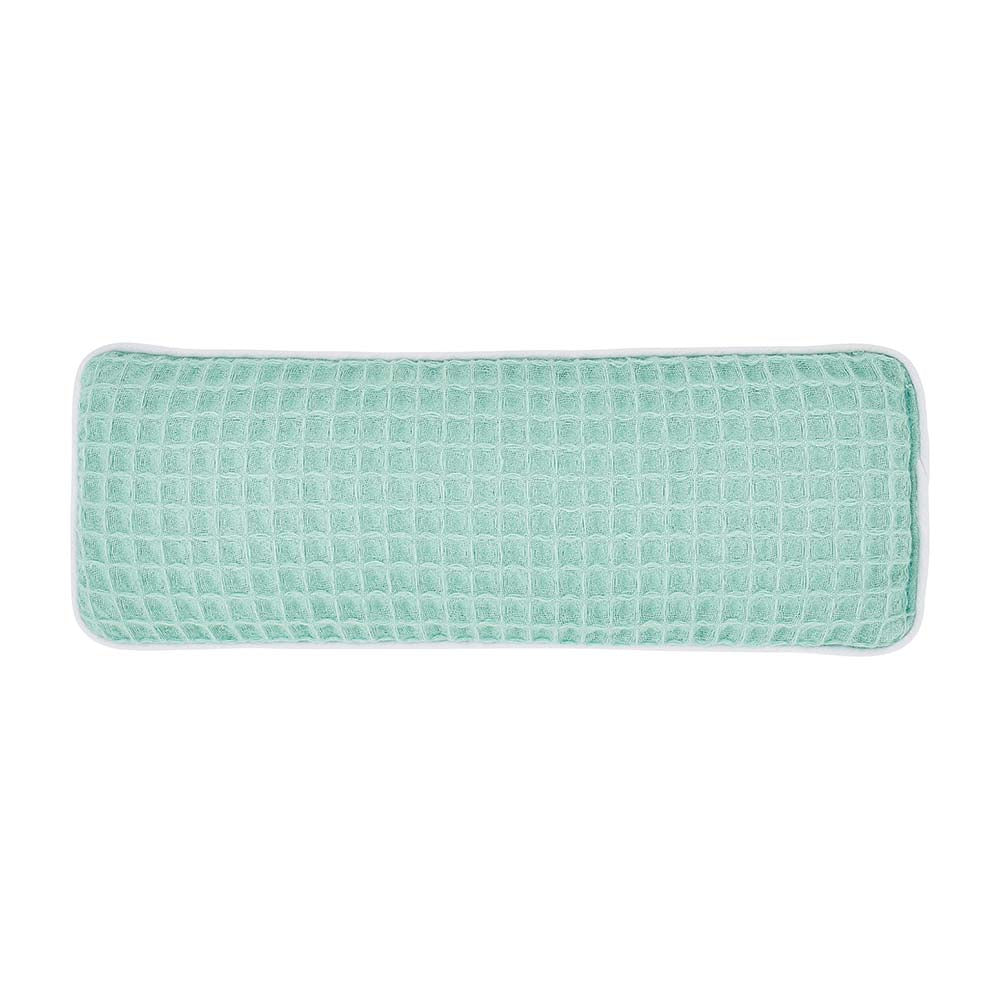 Rectangular green textured eye rest pillow on a white background