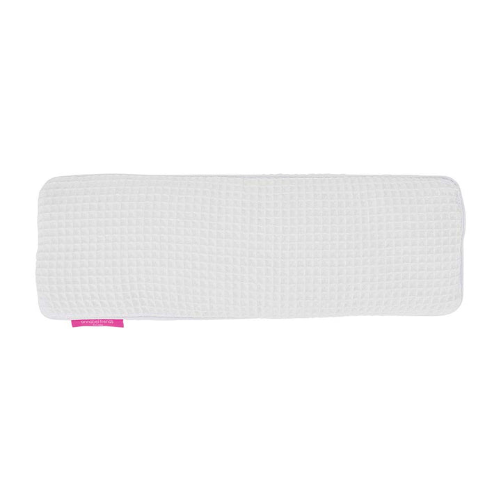 White textured rectangular object with a pink band on a white background