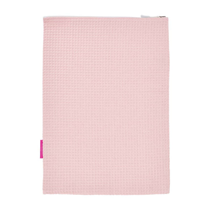 Pink waffle textured laundry bag with a zipper on a white background