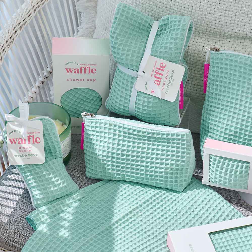 Collection of waffle-textured products including a pouch, cap, and other items on a textured surface.