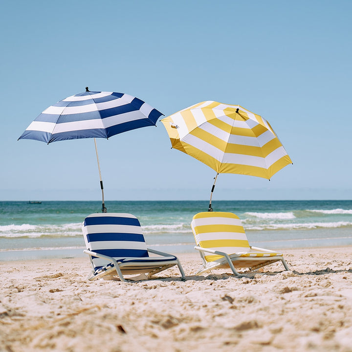 Deluxe beach chairs in nay and yellow stripe, with beach umbrellas attached to chairs
